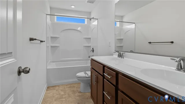 a bathroom with a granite countertop sink a toilet and shower