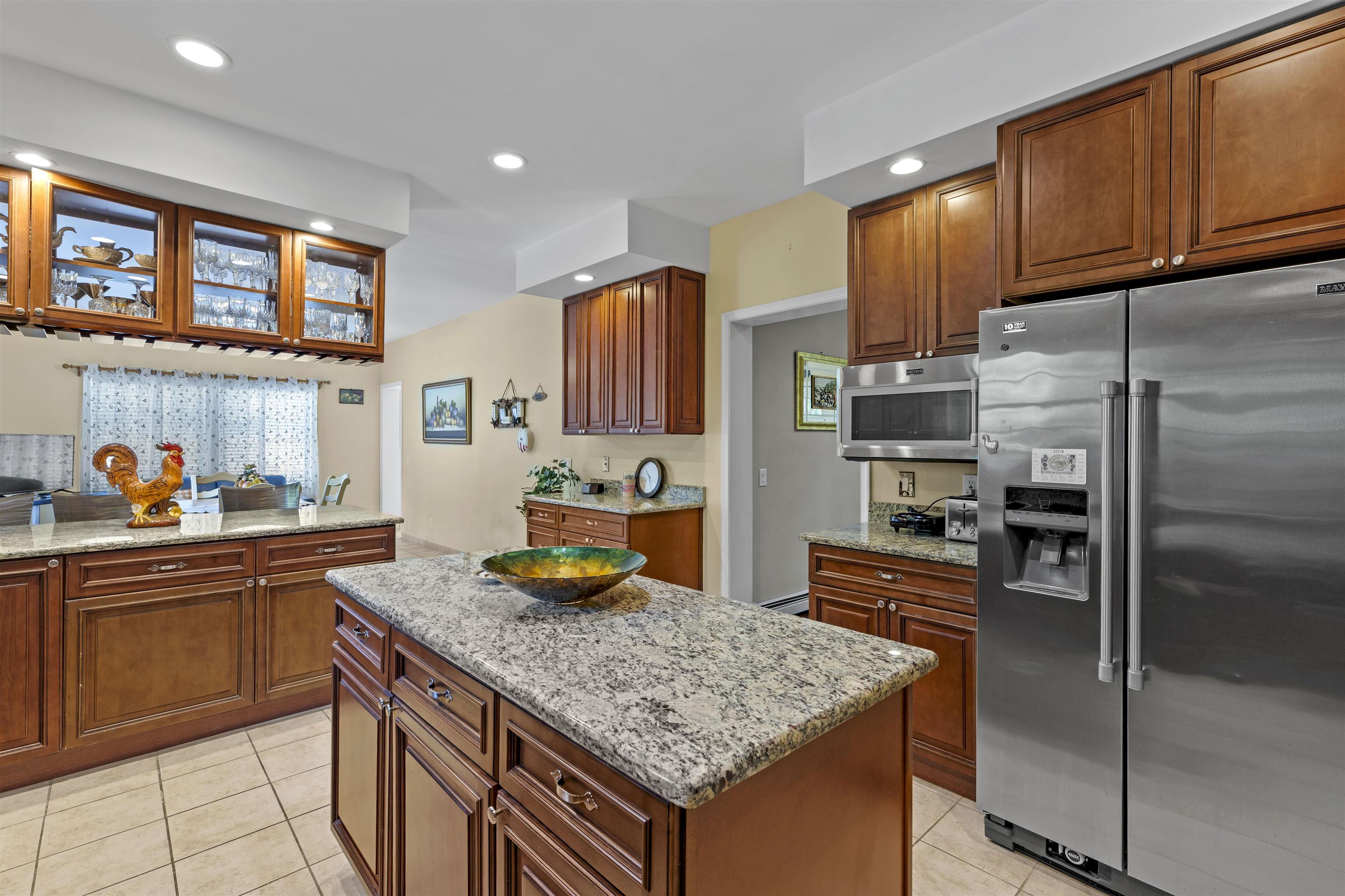 551 Shunpike Road Cape May Court House, NJ 08210 - Photo 5 of 47 a kitchen with stainless steel appliances granite countertop a sink stove and refrigerator