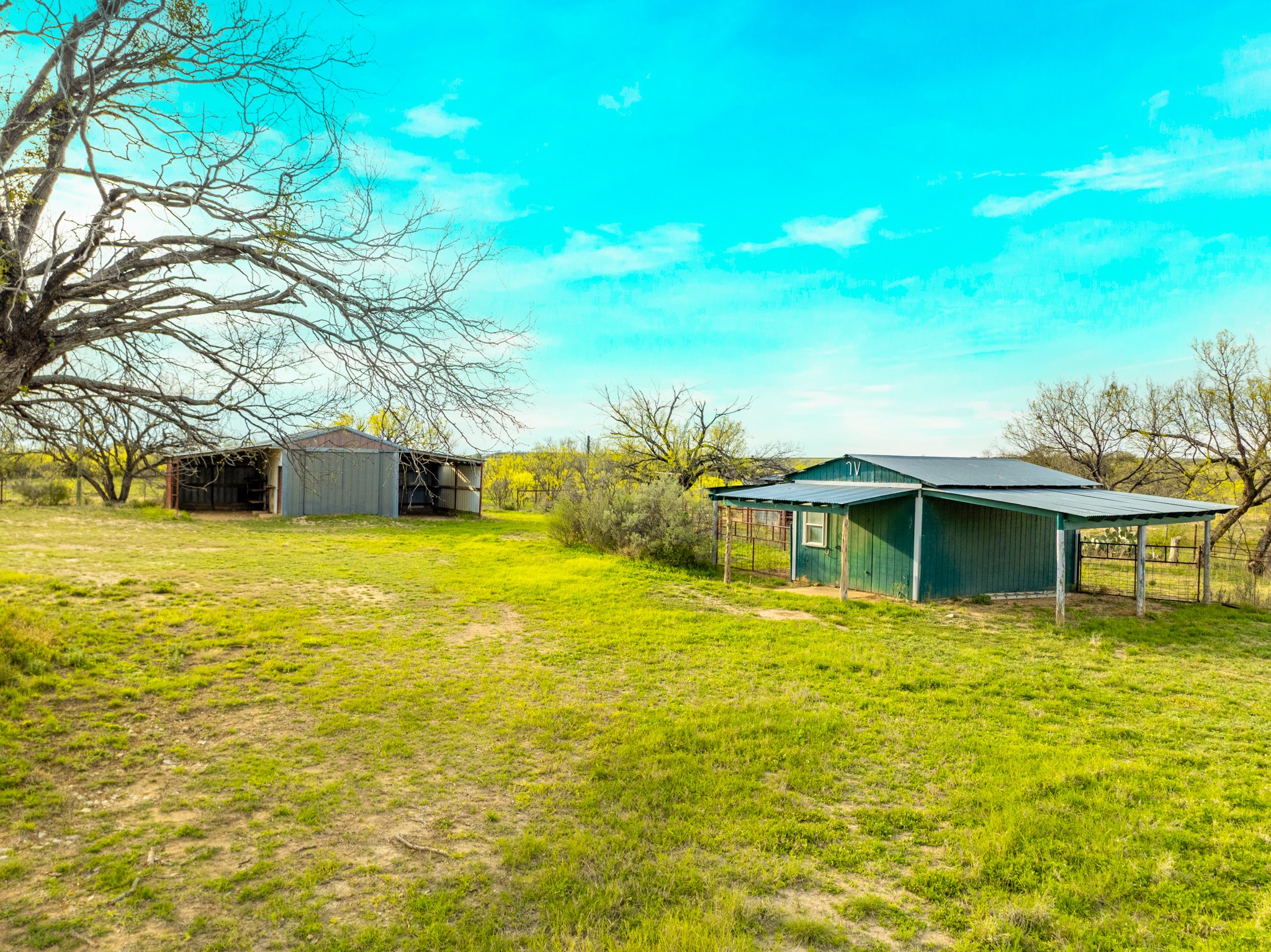 2145 County Road 320 Lohn, TX 76852 - Photo 4 of 39 View of grassy yard with an outbuilding and a carport