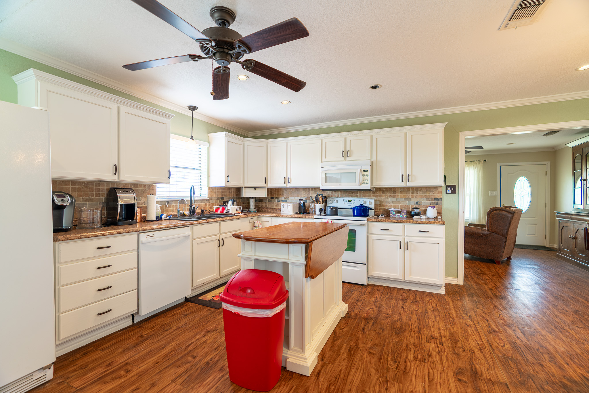 2145 County Road 320 Lohn, TX 76852 - Photo 5 of 40 a kitchen with granite countertop a sink cabinets stainless steel appliances and a window