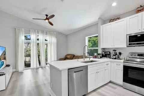 a kitchen with stainless steel appliances a refrigerator sink and microwave