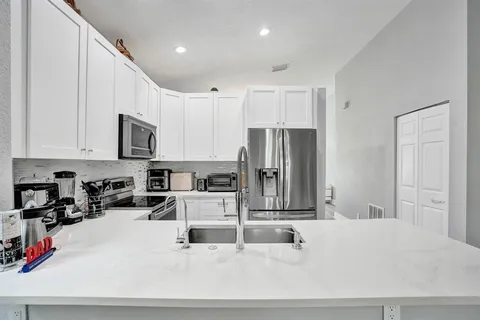 a kitchen with a sink stove and microwave