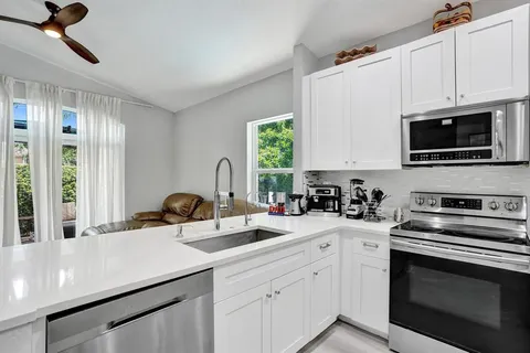 a living room with furniture and kitchen view