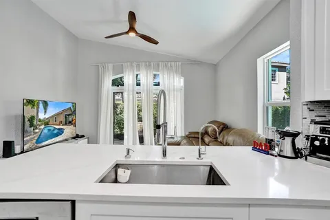 a living room with furniture and kitchen view