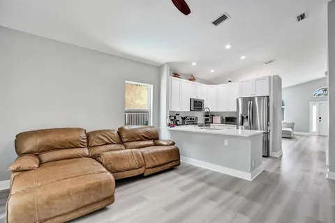 a bedroom with a bed and a large mirror