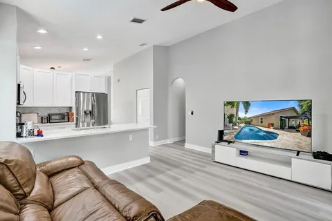 a bedroom with a bed and a mirror on the dresser