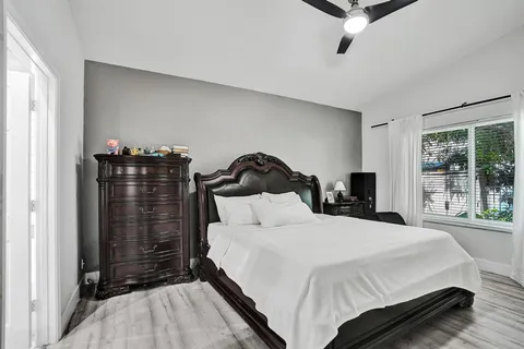 a bathroom with a granite countertop sink mirror and toilet