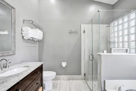 a utility room with stainless steel appliances granite countertop a sink and a white cabinets