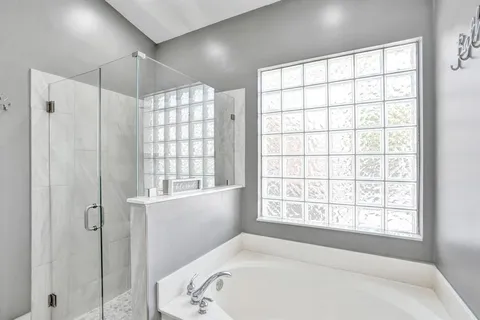 a bathroom with a sink vanity tub and shower