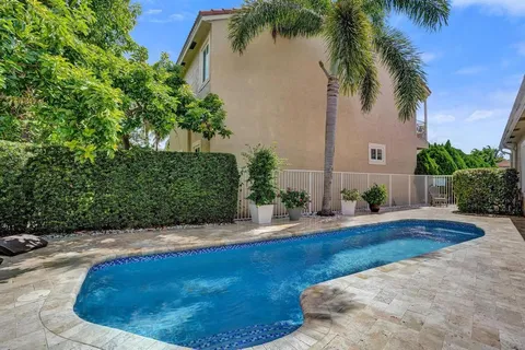 a swimming pool with outdoor seating and yard
