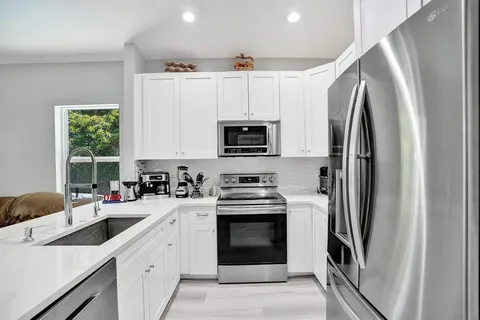 a living room with furniture and large windows