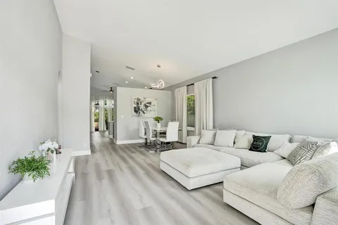a living room with furniture and view of kitchen