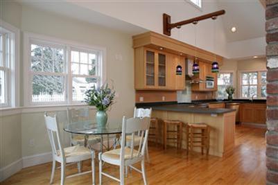 304 Parker Road Osterville, MA 02655 - Photo 7 of 15 a kitchen with a table chairs and wooden floor
