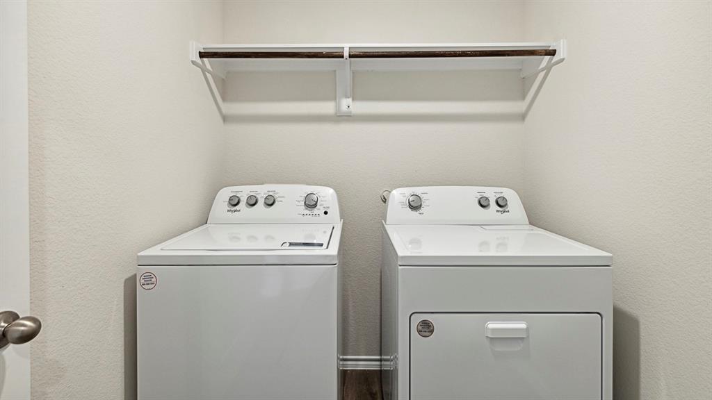 120 Pheasant Run Road Lavon, TX 75166 - Photo 16 of 17 Laundry area featuring washing machine and dryer and a textured wall