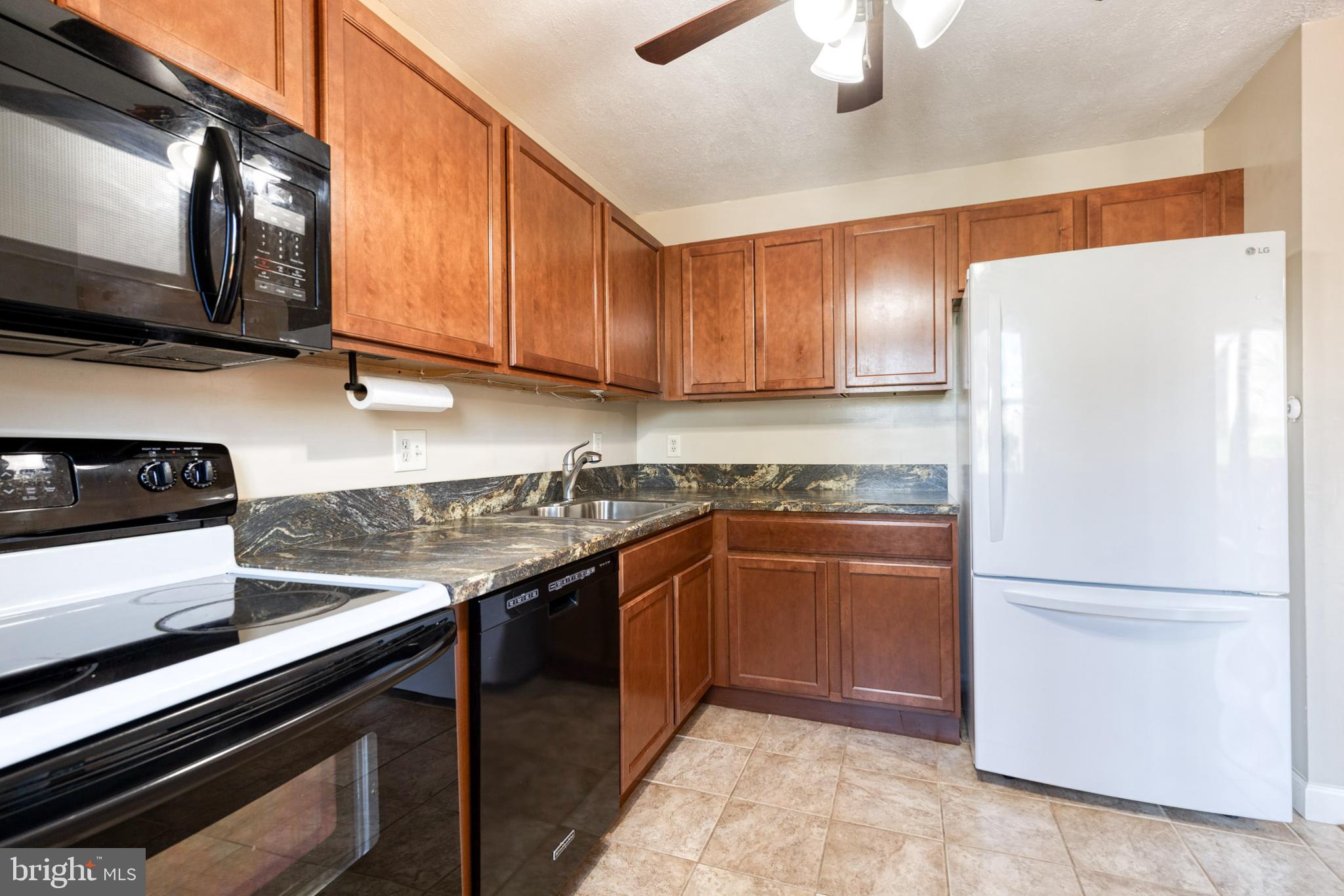 28 Patrick Court Abingdon, MD 21009 - Photo 12 of 22 a kitchen with stainless steel appliances granite countertop a refrigerator a stove and a sink