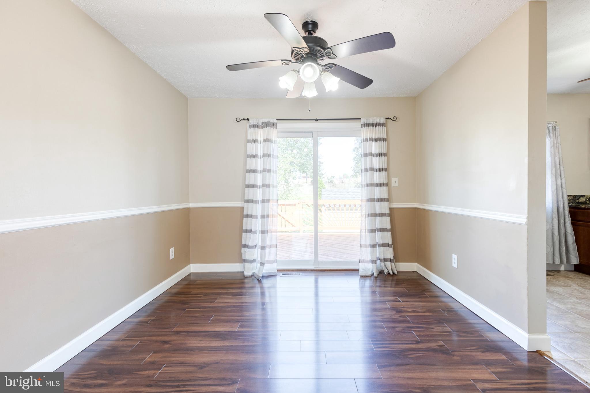 28 Patrick Court Abingdon, MD 21009 - Photo 7 of 22 a view of empty room with wooden floor and fan