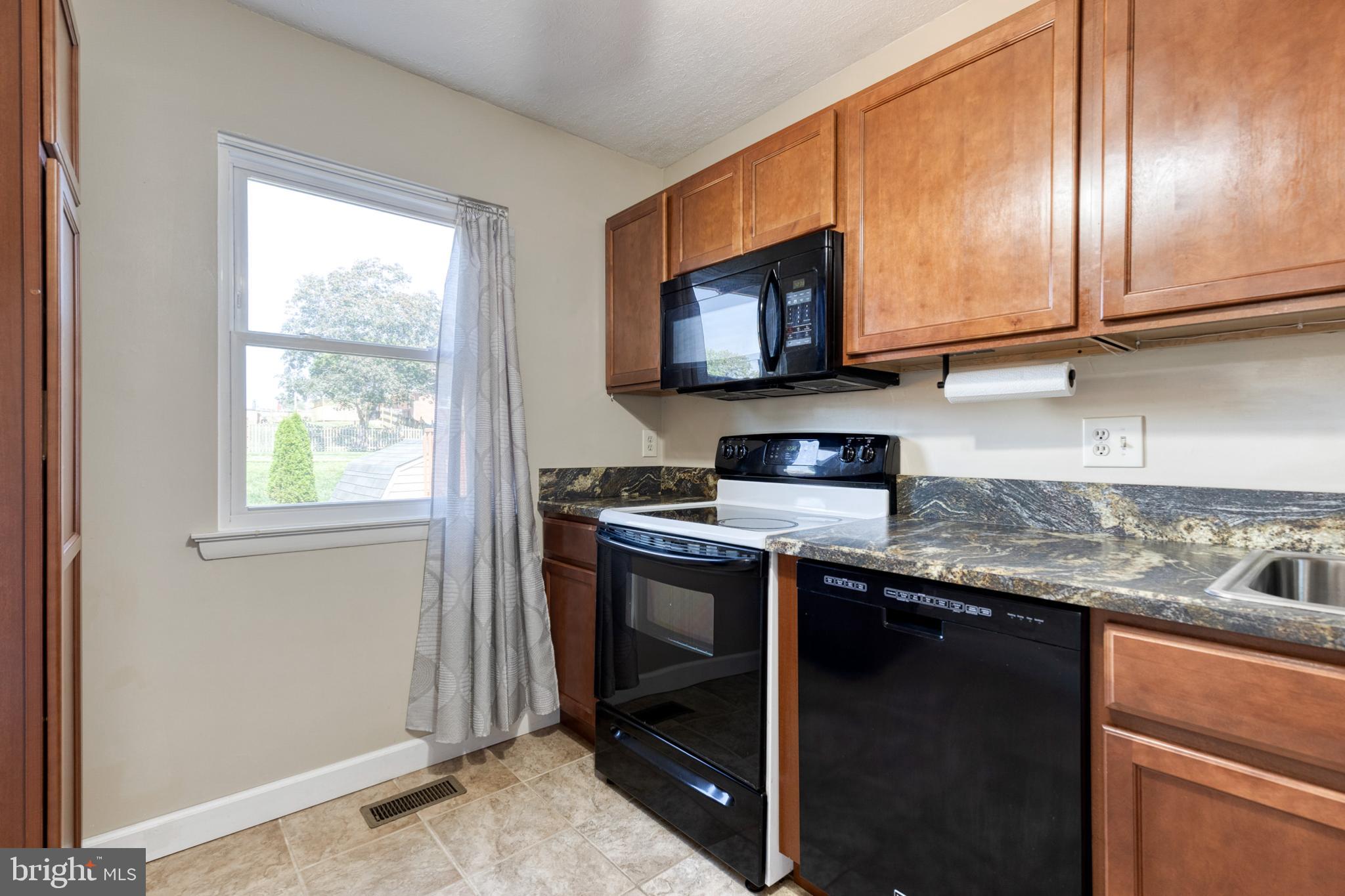 28 Patrick Court Abingdon, MD 21009 - Photo 10 of 22 a kitchen with stainless steel appliances granite countertop a stove a sink and a microwave