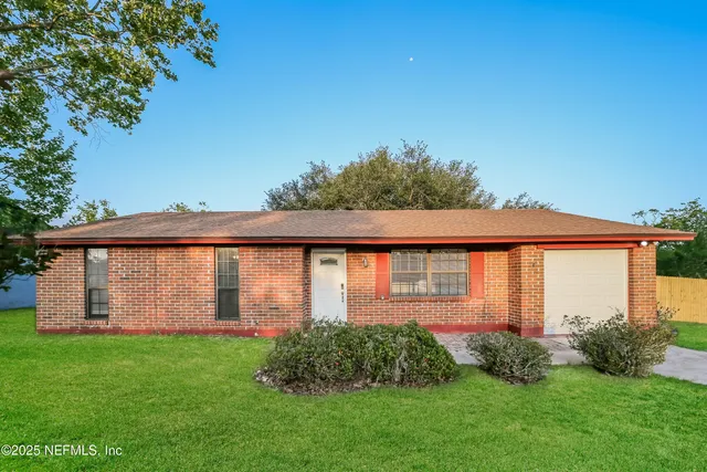 a front view of house with yard and green space