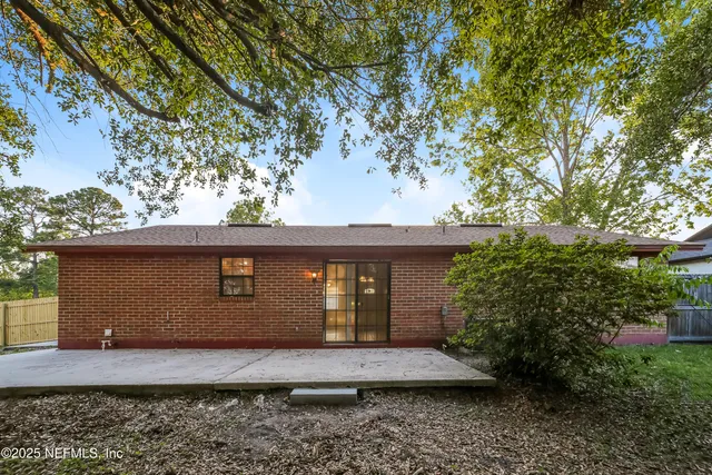 a view of a house with a large tree