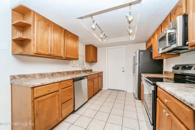 a kitchen with stainless steel appliances granite countertop a sink and cabinets