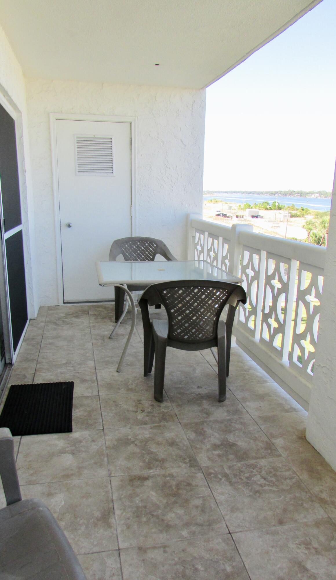 909 Santa Rosa Boulevard, Unit 555 Fort Walton Beach, FL 32548 - Photo 11 of 12 a living room with a table and a table