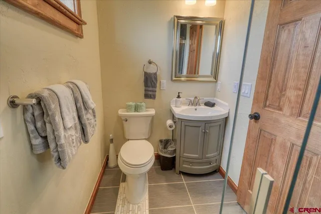 a bathroom with a sink toilet and a mirror