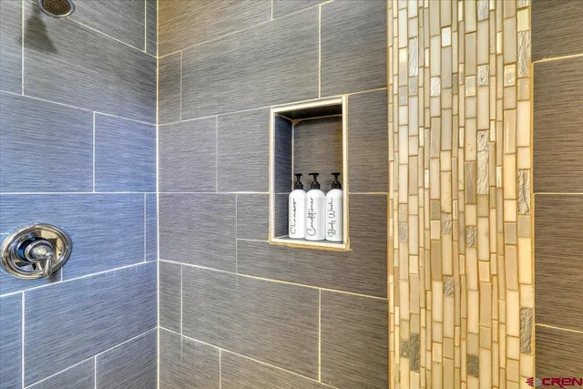 a bathroom with a window and a shower