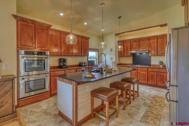 a kitchen with stainless steel appliances granite countertop a sink and cabinets