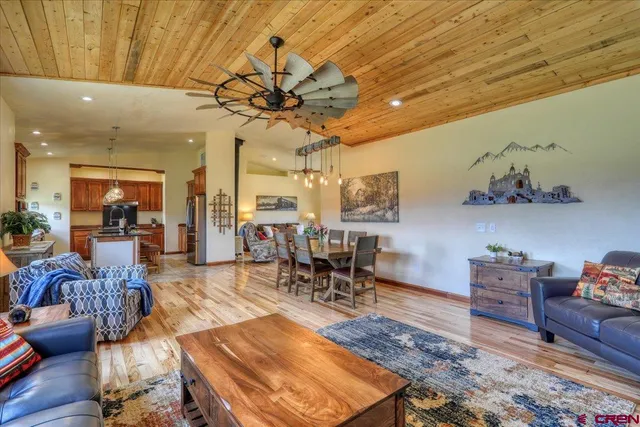 a living room with lots of furniture and a chandelier