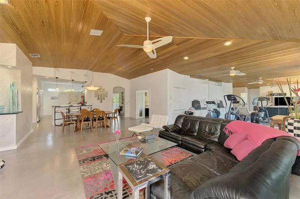 a view of a dining room with furniture a chandelier and a large window
