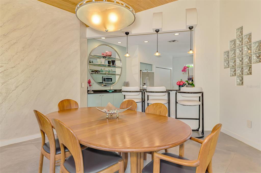 412 Treasure Boat Way Sarasota, FL 34242 - Photo 22 of 91 a view of a dining room with furniture and wooden floor