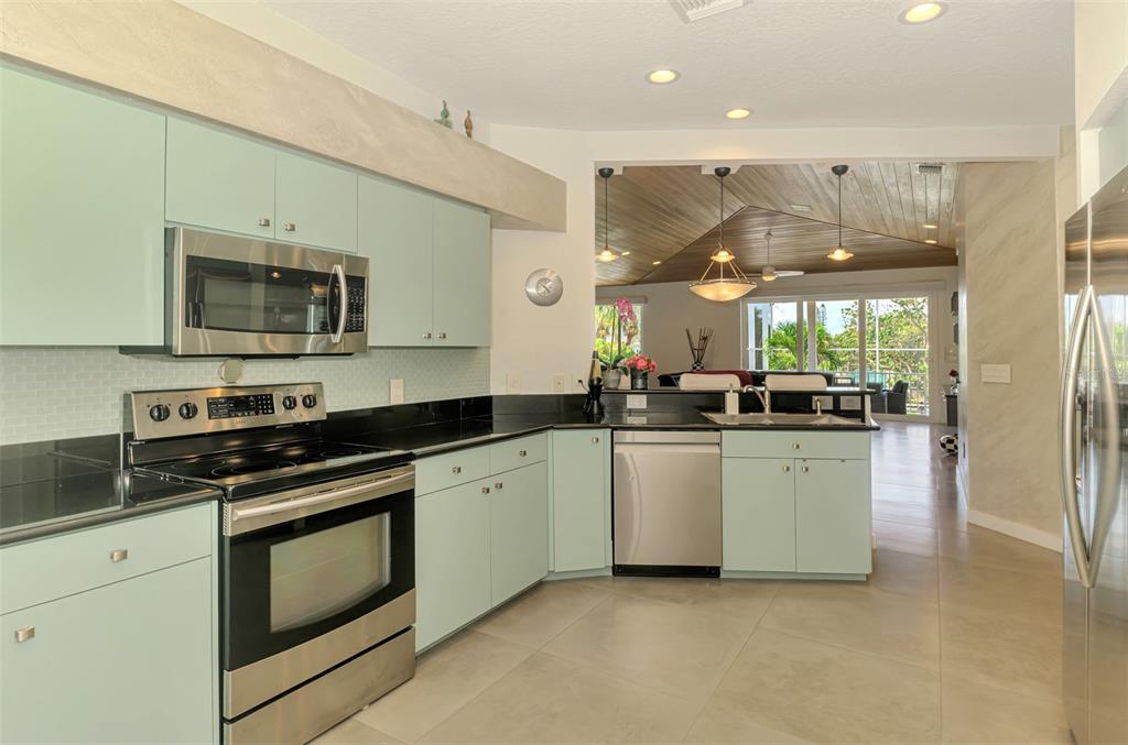 412 Treasure Boat Way Sarasota, FL 34242 - Photo 29 of 91 a kitchen with stainless steel appliances granite countertop a stove a sink and a microwave