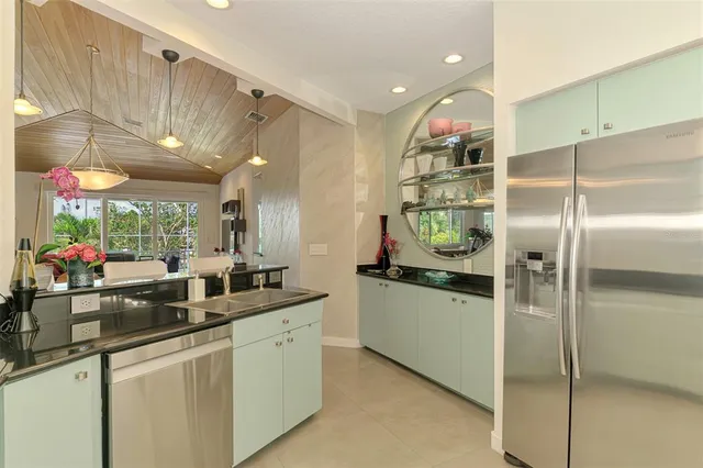 a view of house with backyard and glass windows