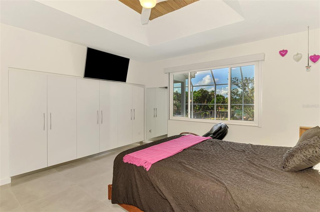 412 Treasure Boat Way Sarasota, FL 34242 - Photo 33 of 91 a bedroom with a bed and a flat screen tv