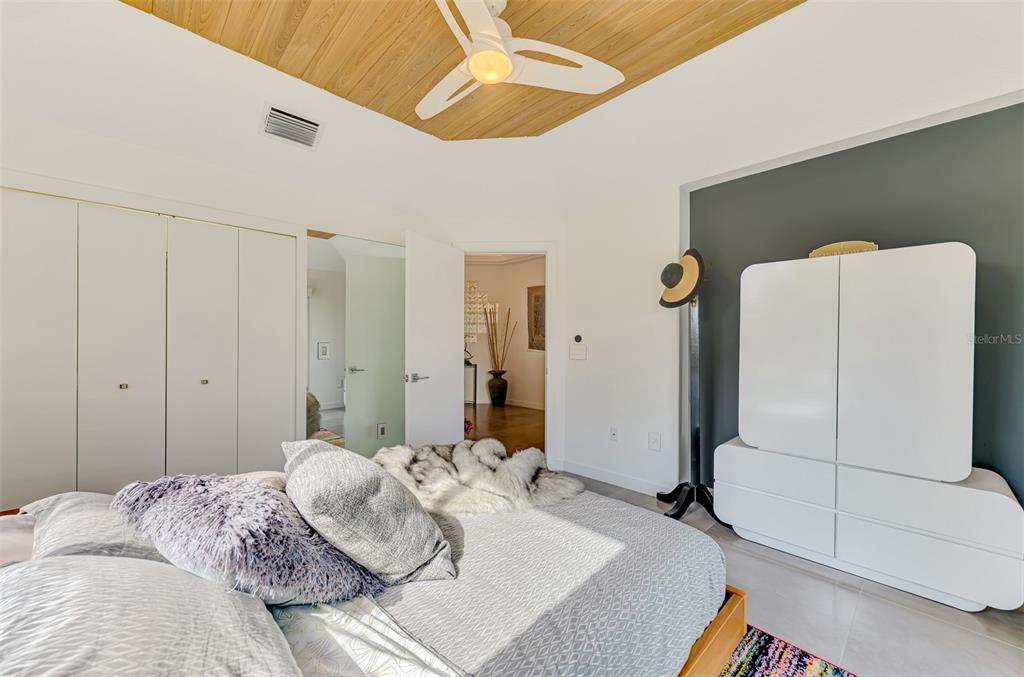 412 Treasure Boat Way Sarasota, FL 34242 - Photo 41 of 91 a bedroom with a bed and a chandelier