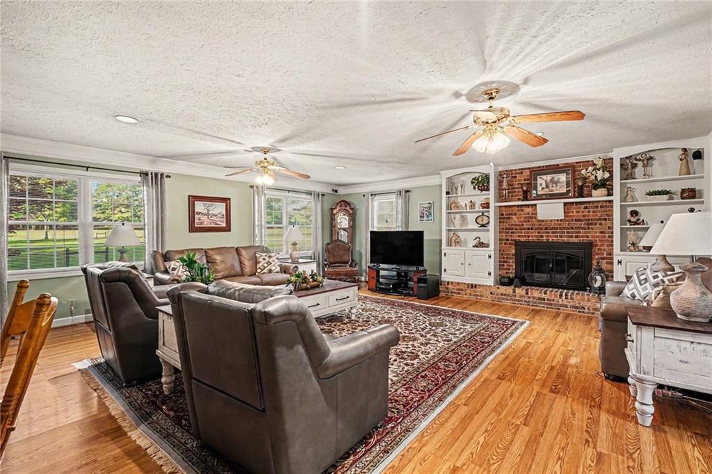 740 Smyrna Road Southwest Conyers, GA 30094 - Photo 4 of 27 a living room with furniture fireplace and a flat screen tv