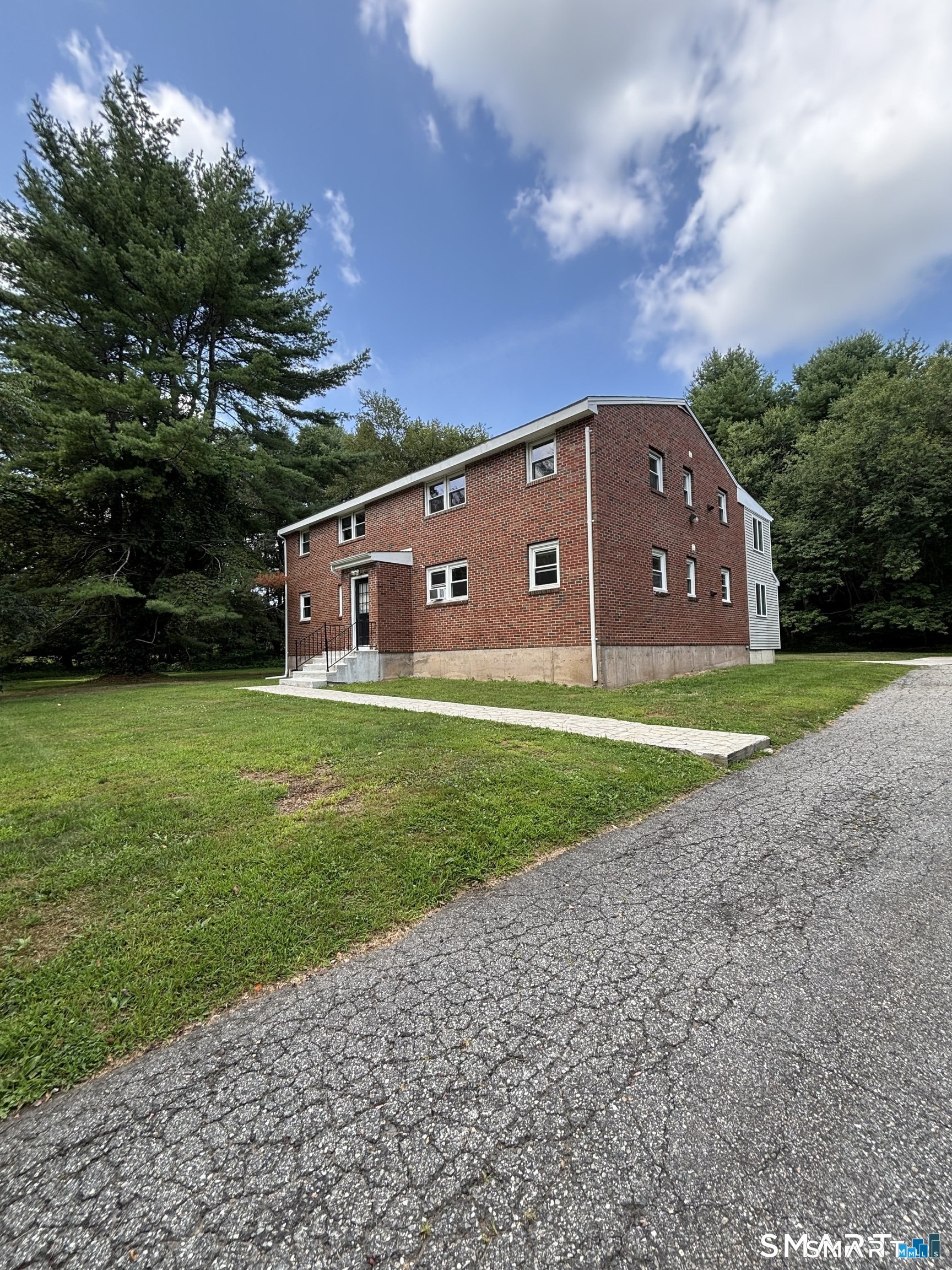 103 Hebron Road Marlborough, CT 06447 - Photo 2 of 10 a backyard of a house with lots of green space and garden