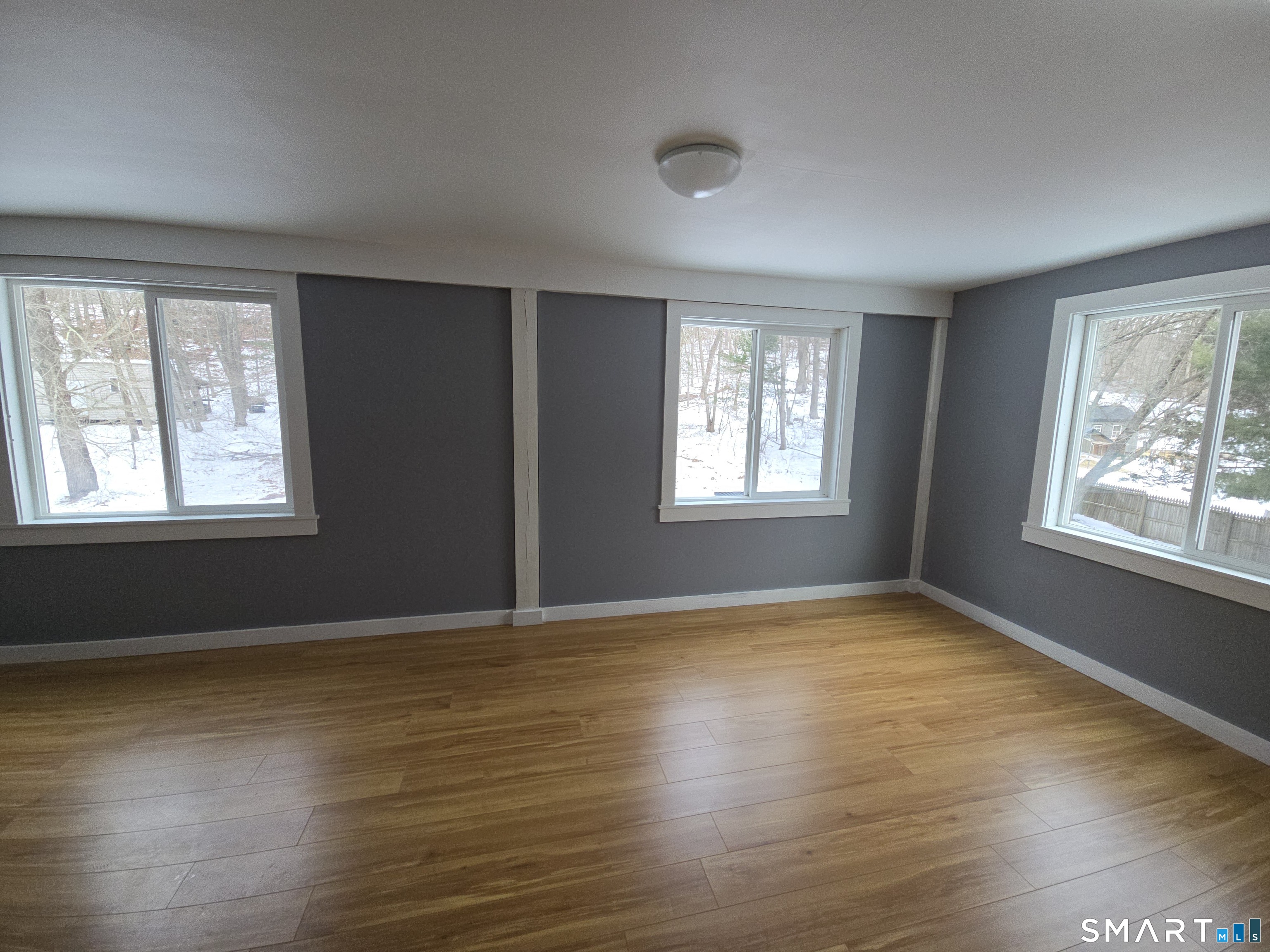 103 Hebron Road Marlborough, CT 06447 - Photo 6 of 10 a view of an empty room with wooden floor and a window