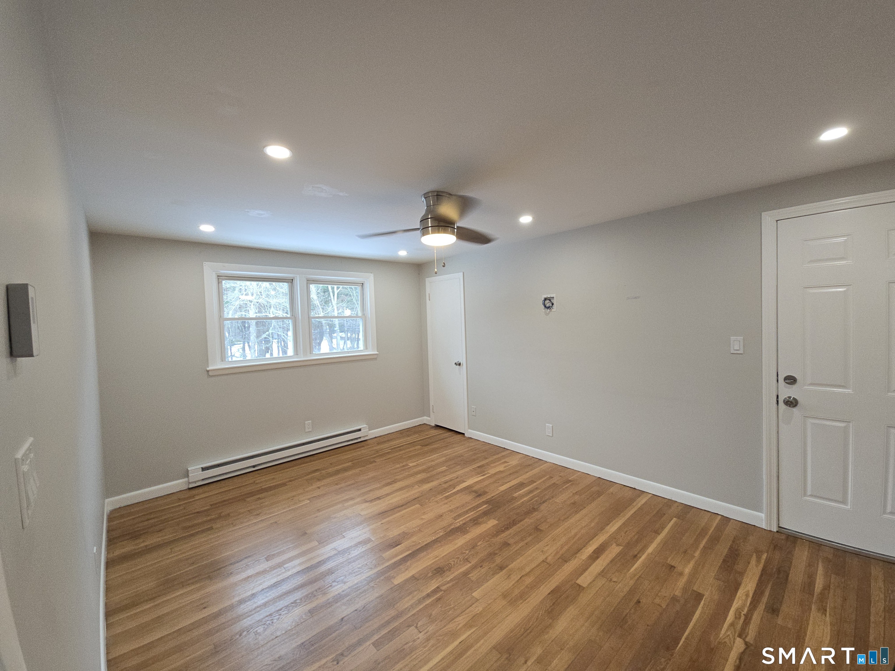103 Hebron Road Marlborough, CT 06447 - Photo 10 of 10 a view of an empty room with wooden floor and a window