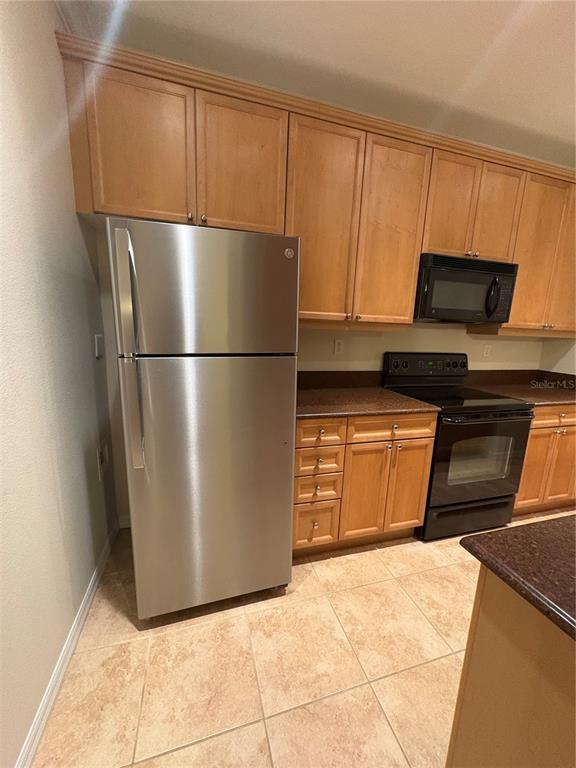 8168 Boat Hook Loop, Unit 707 Windermere, FL 34786 - Photo 11 of 17 a kitchen with a refrigerator and a microwave