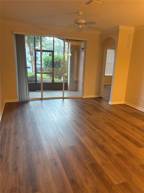 8168 Boat Hook Loop, Unit 707 Windermere, FL 34786 - Photo 3 of 17 a view of an empty room with wooden floor and a window