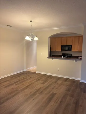 a view of a kitchen with a sink microwave and cabinets