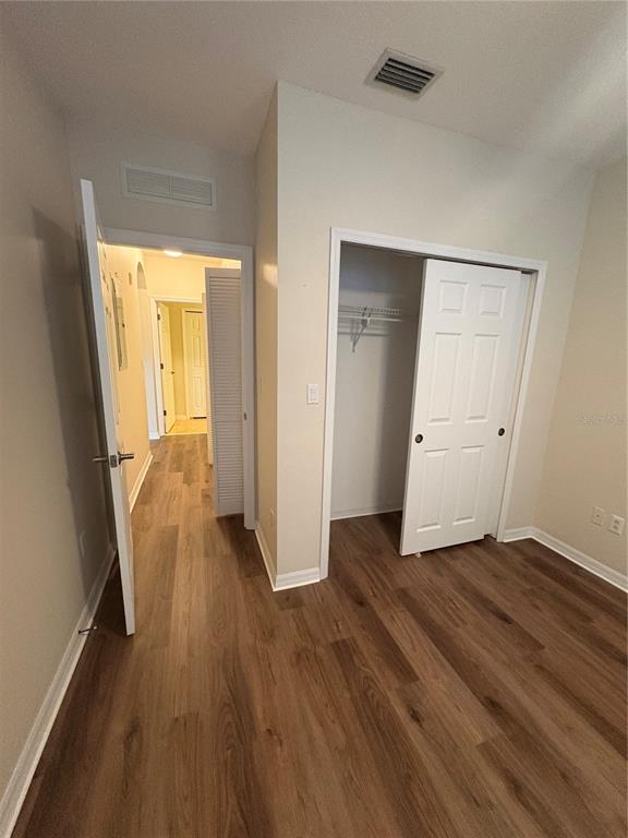 8168 Boat Hook Loop, Unit 707 Windermere, FL 34786 - Photo 7 of 17 an empty room with wooden floor and windows