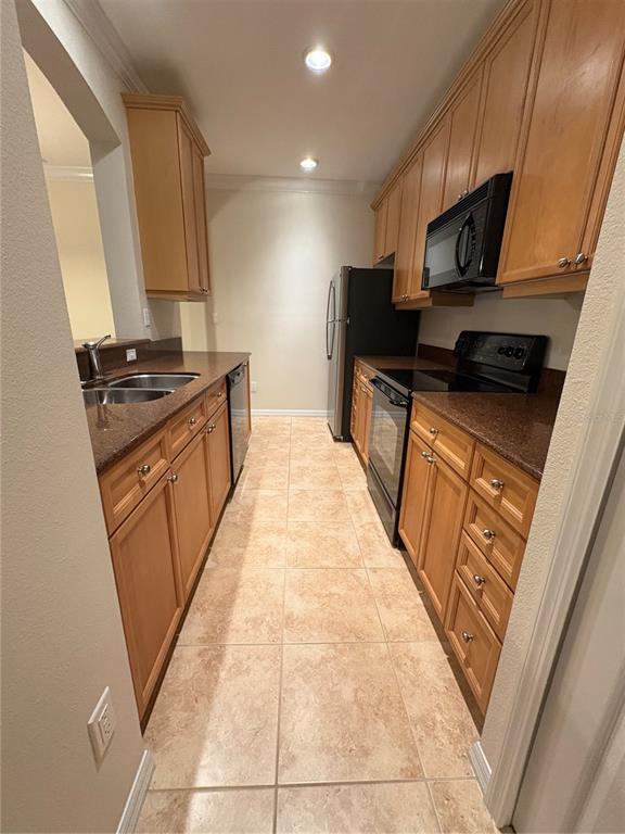 8168 Boat Hook Loop, Unit 707 Windermere, FL 34786 - Photo 10 of 17 a kitchen with stainless steel appliances granite countertop a stove a sink and a refrigerator