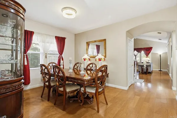 a view of a dining room with furniture and a potted plant