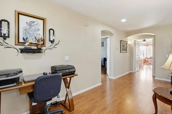 a view of a workspace with furniture and wooden floor