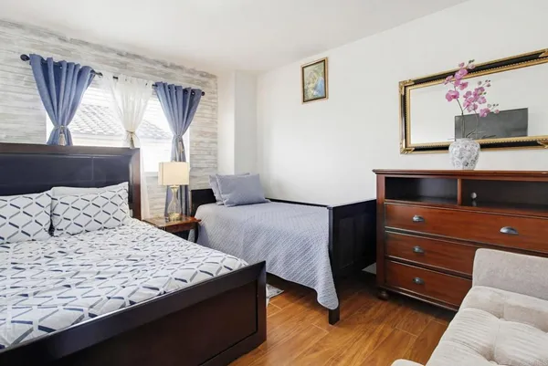 a bedroom with two beds and a window