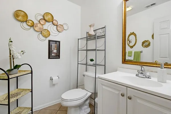 a bathroom with a sink mirror vanity and toilet