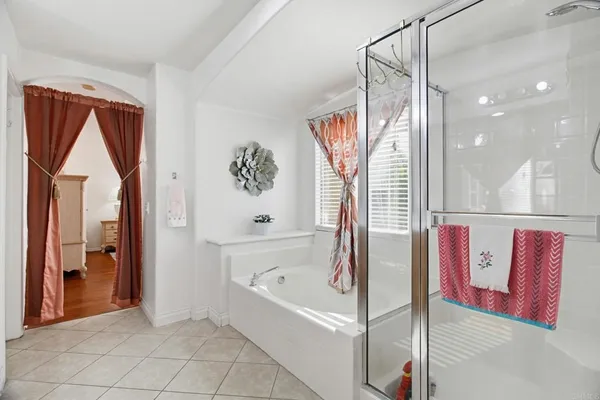 a bathroom with a bathtub and shower