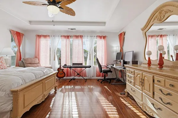 a spacious bedroom with a bed and a chandelier
